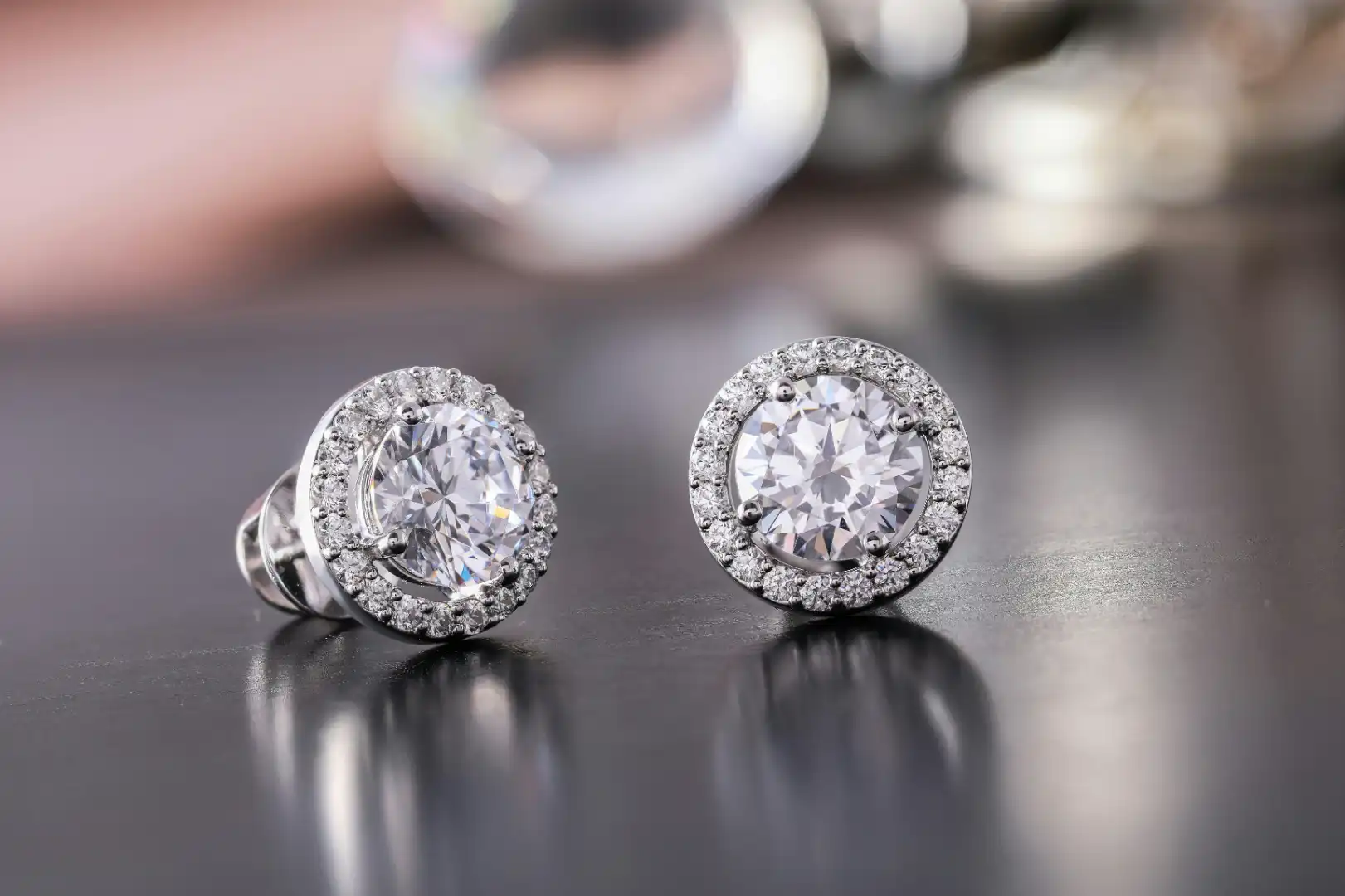 Pair of sparkling diamond stud earrings after professional cleaning and repair service in Milton.