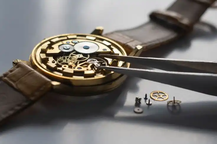 Expert watchmaker repairing a mechanical luxury watch movement in Milton, Ontario.